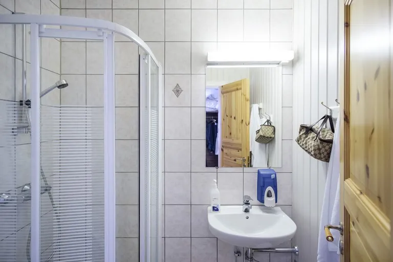 A bright, renovated bathroom with white tiles